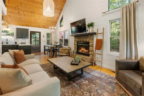 a living room with furniture fireplace and flat screen tv