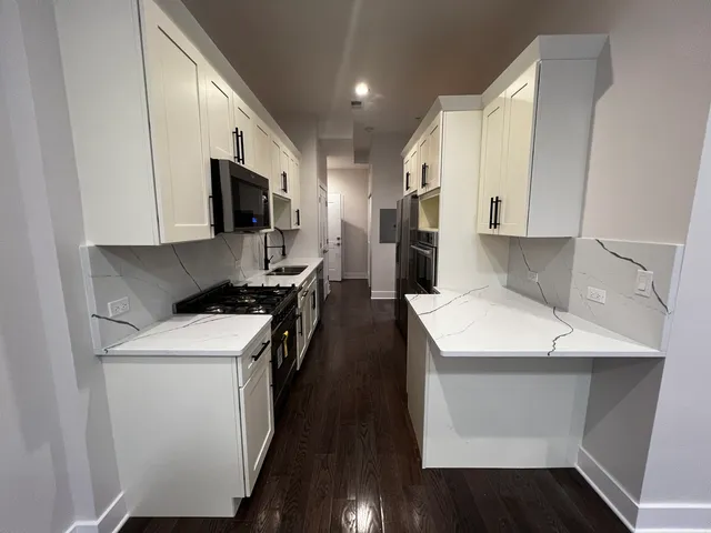 a kitchen with a sink a stove and refrigerator