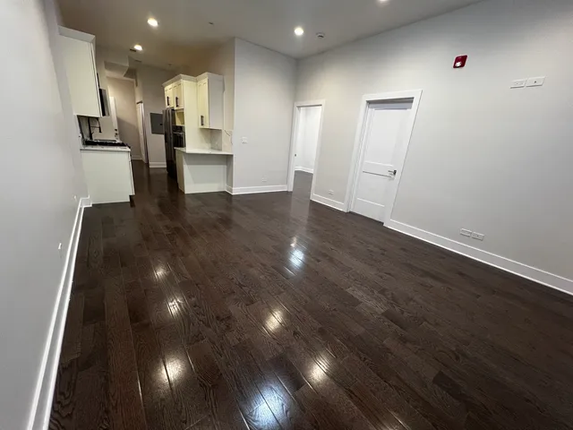 a view of kitchen with cabinets and wooden floor