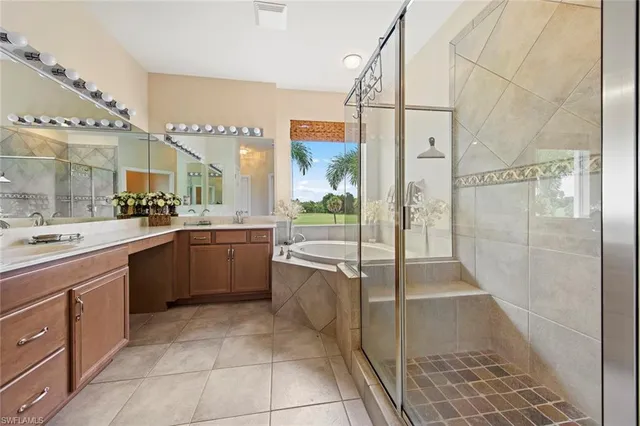 a large kitchen with a large counter top a sink a counter space and stainless steel appliances