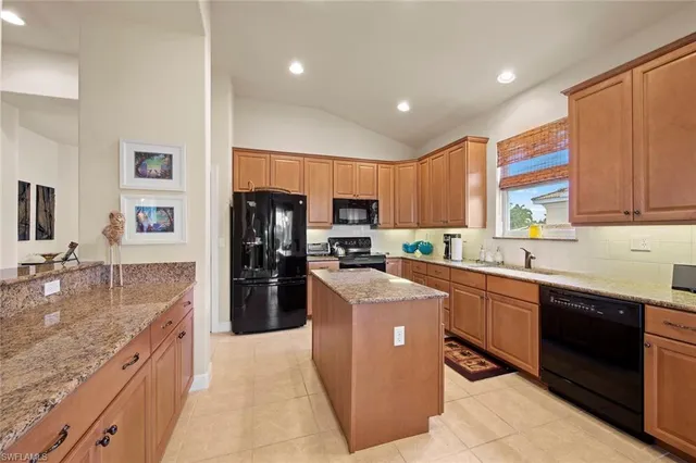 a kitchen with stainless steel appliances granite countertop a refrigerator stove microwave and sink