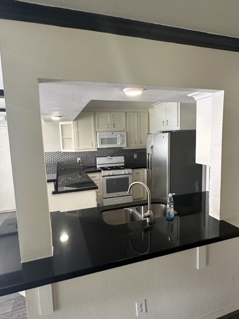 3862 Wichita Street Houston, TX 77004 - Photo 9 of 20 a kitchen with a sink and refrigerator