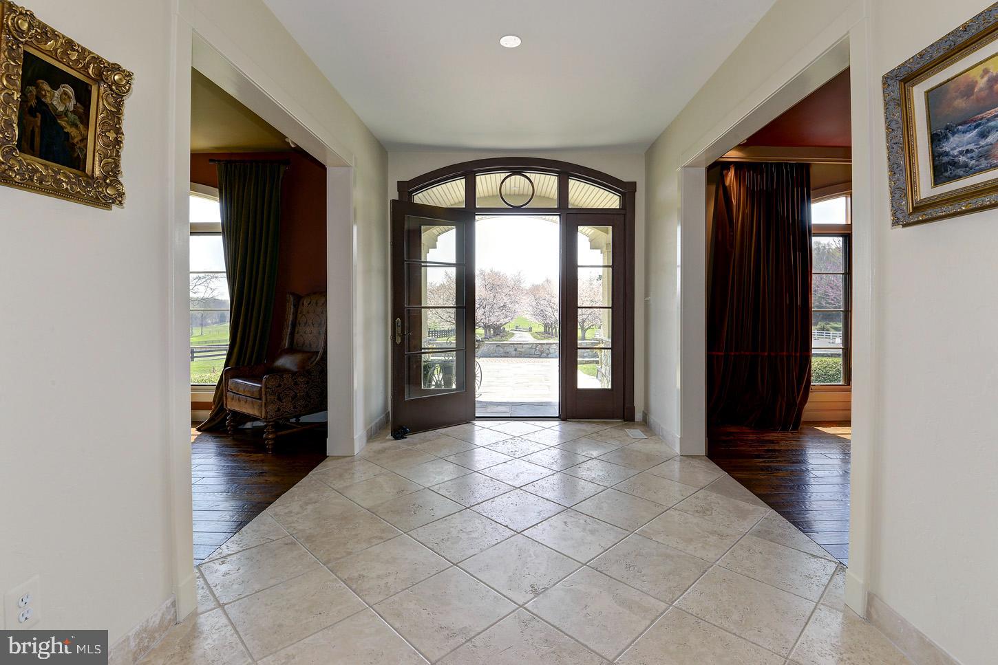16704 Thurston Road Dickerson, MD 20842 - Photo 16 of 101 a view of a hallway with wooden floor and a living room