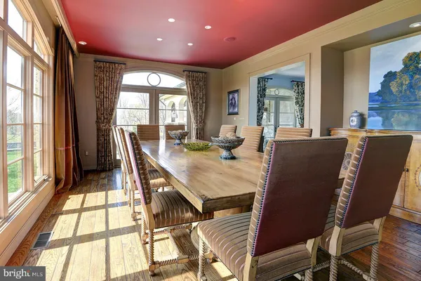 a view of a dining room with furniture and chandelier