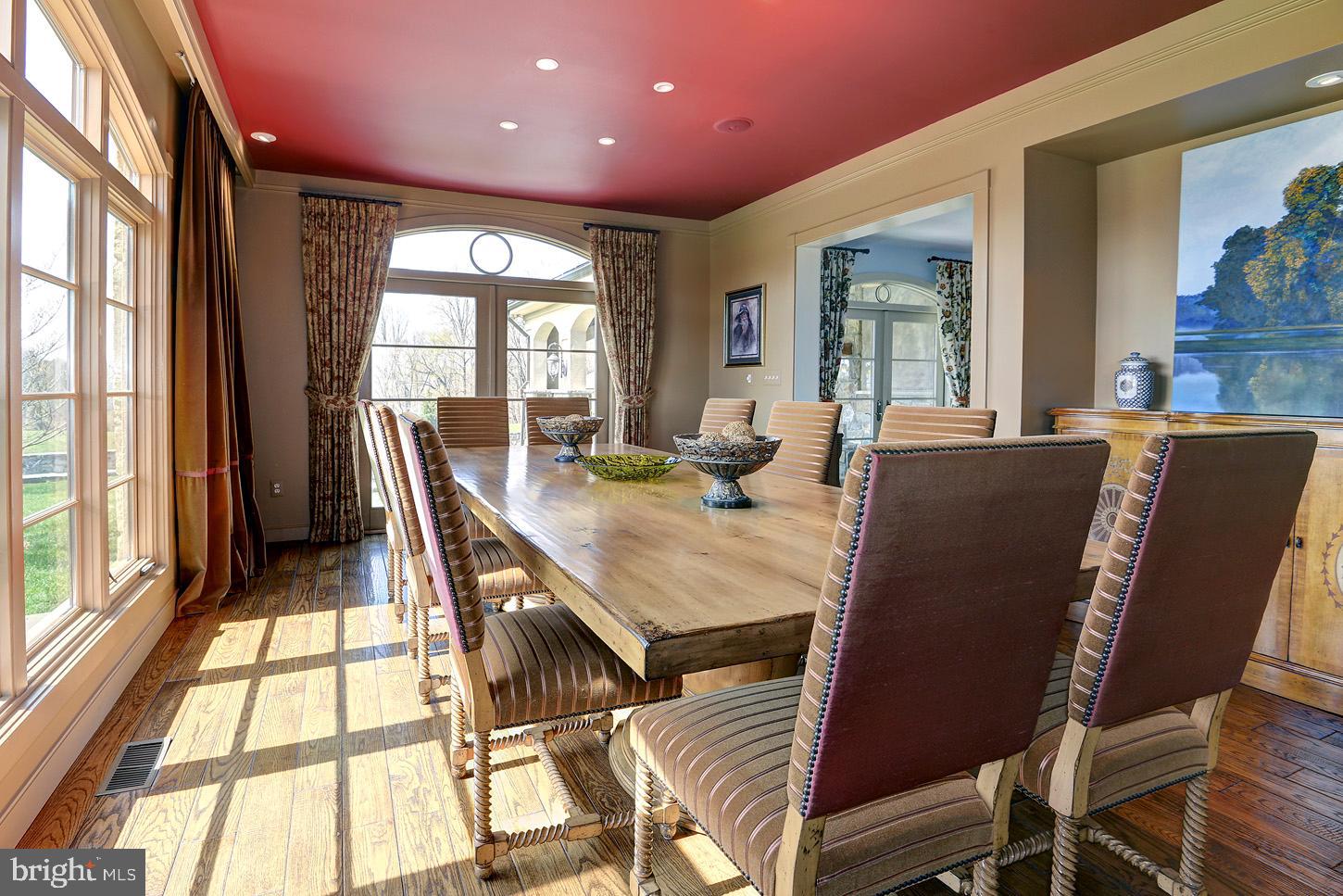 16704 Thurston Road Dickerson, MD 20842 - Photo 19 of 101 a view of a dining room with furniture a chandelier and wooden floor