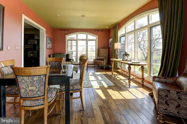 a living room with furniture and a floor to ceiling window