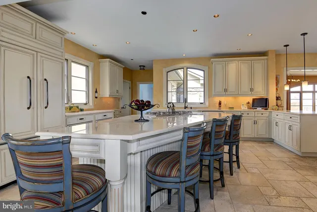 a kitchen with white cabinets sink and white appliances
