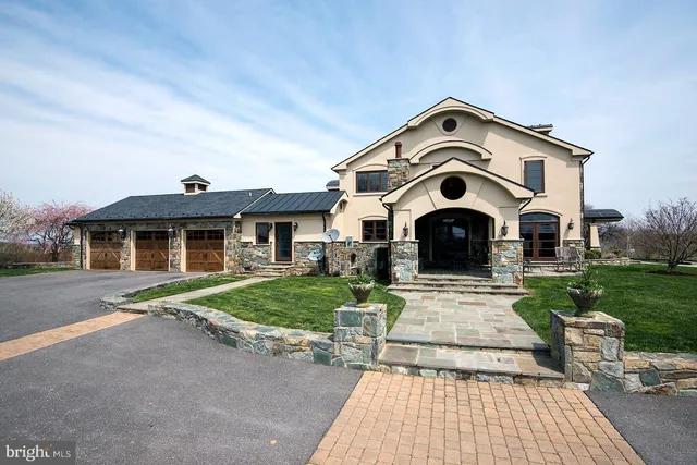 a view of a big house with a big yard and potted plants