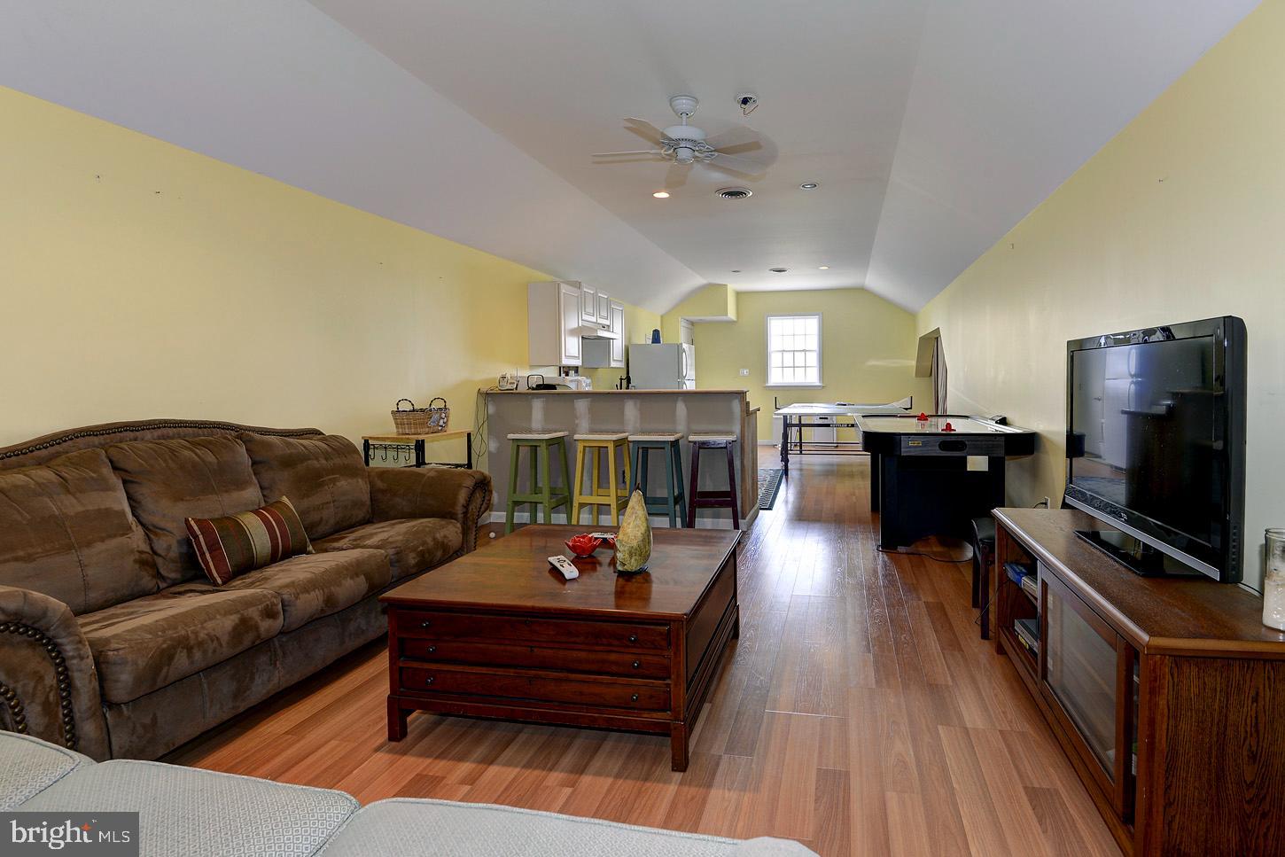 16704 Thurston Road Dickerson, MD 20842 - Photo 65 of 101 a living room with furniture and a flat screen tv