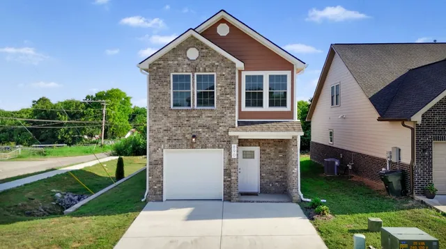 an aerial view of residential houses with outdoor space and street view
