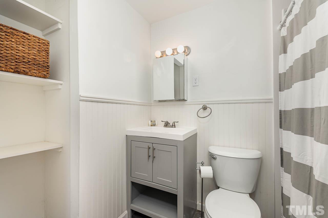 1703 Fountain Ridge Road Chapel Hill, NC 27517 - Photo 25 of 35 a bathroom with a toilet a sink and mirror