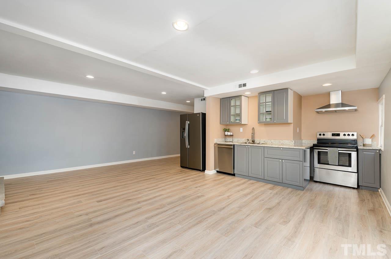 1703 Fountain Ridge Road Chapel Hill, NC 27517 - Photo 27 of 35 a large kitchen with a wooden floor and stainless steel appliances
