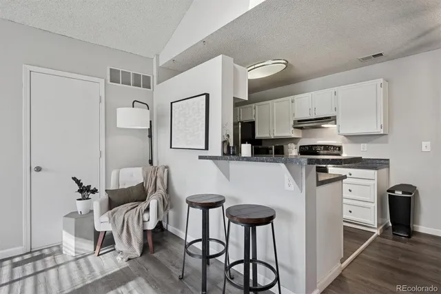 a kitchen with stainless steel appliances a refrigerator and a stove top oven
