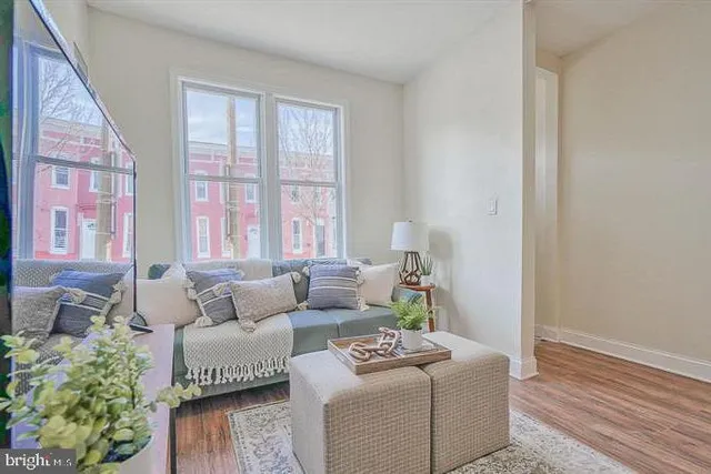 a kitchen with stainless steel appliances granite countertop a refrigerator sink and wooden floor