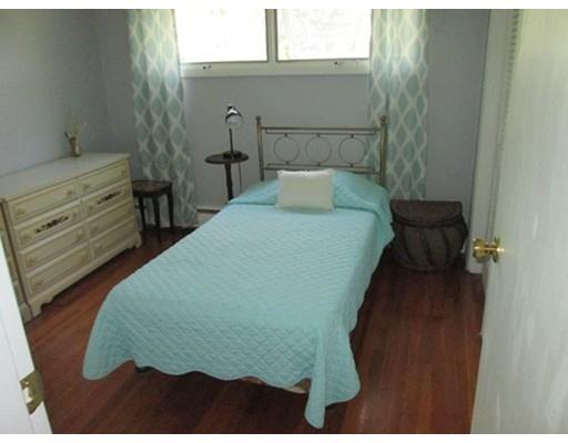 45 Preston Road Attleboro, MA 02703 - Photo 20 of 28 a bed sitting in a bedroom next to a bathroom