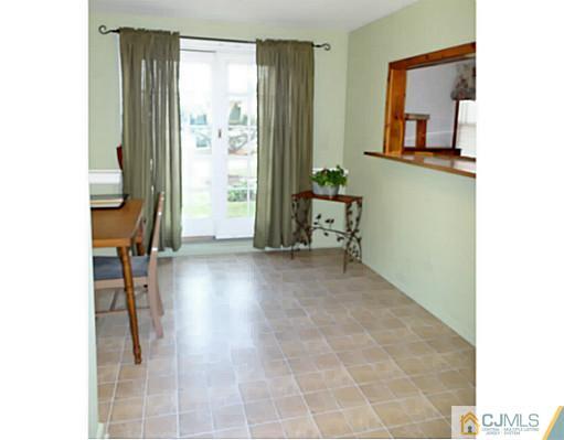 786 Old Raritan Road Edison, NJ 08820 - Photo 11 of 17 a view of a hallway with paintings on the wall
