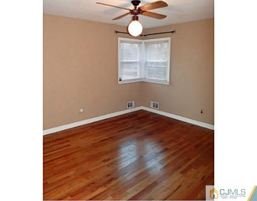 786 Old Raritan Road Edison, NJ 08820 - Photo 14 of 17 a view of room with wooden floor and ceiling fan