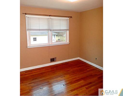 786 Old Raritan Road Edison, NJ 08820 - Photo 15 of 17 a view of an empty room with wooden floor and a window