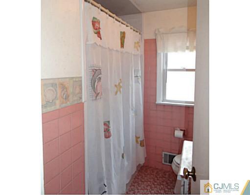 786 Old Raritan Road Edison, NJ 08820 - Photo 17 of 17 a bathroom with a sink and a shower curtain