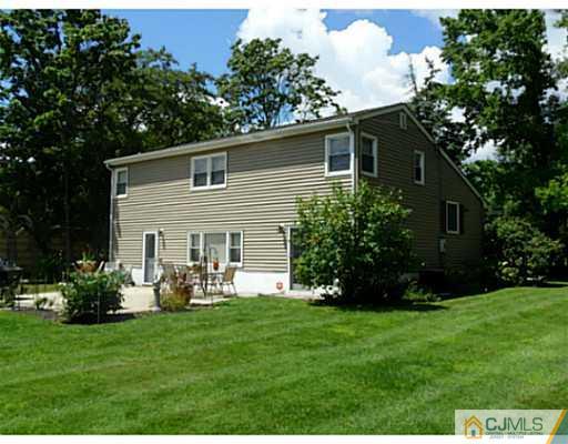 786 Old Raritan Road Edison, NJ 08820 - Photo 3 of 17 a front view of house with a garden and patio