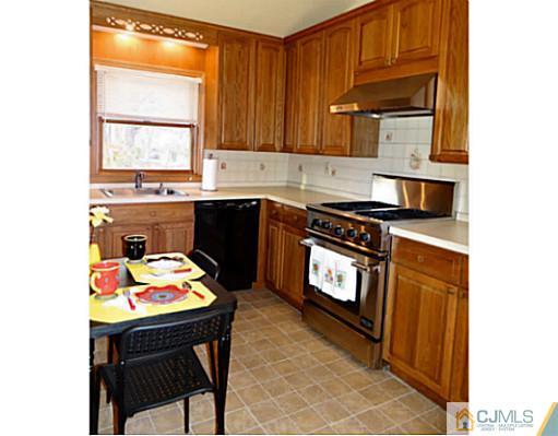 786 Old Raritan Road Edison, NJ 08820 - Photo 6 of 17 a kitchen with stainless steel appliances granite countertop a stove a sink and a microwave