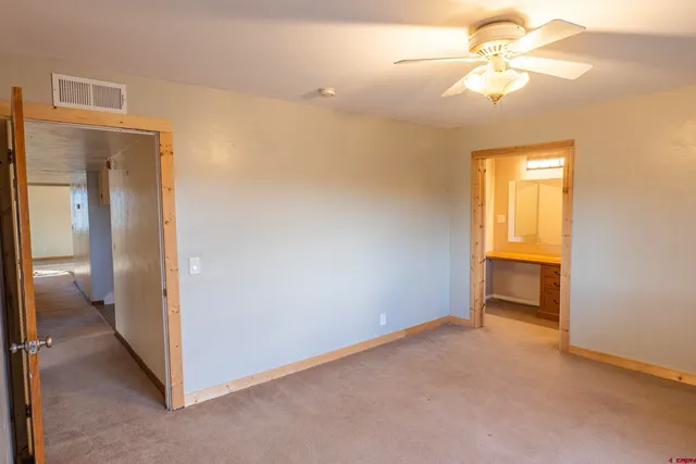 a view of empty room with a ceiling fan