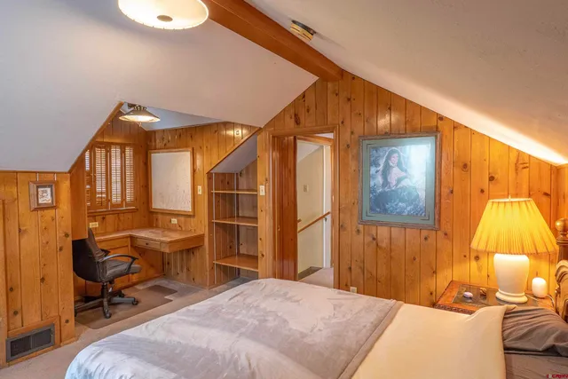 a living room with furniture a couch and wooden floor