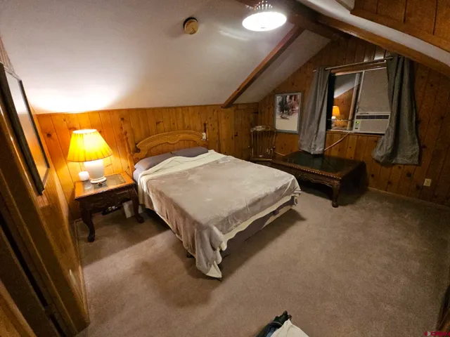 a living room with a large bed and a large window