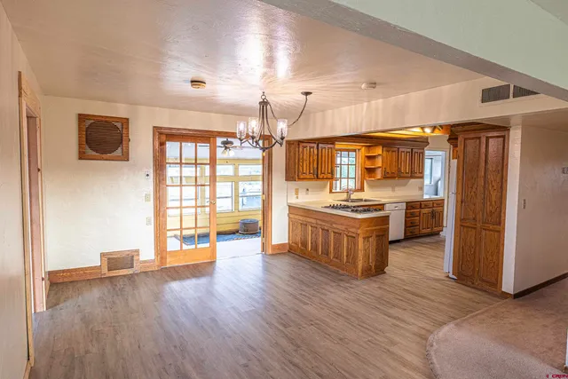 a large room with kitchen view and a window