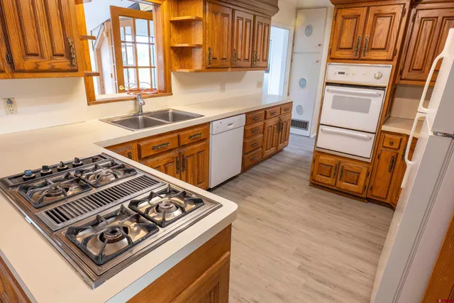 a kitchen with wooden cabinets and a stove top oven