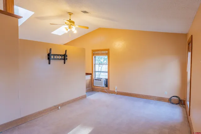 a view of wooden floor in a hall with a window