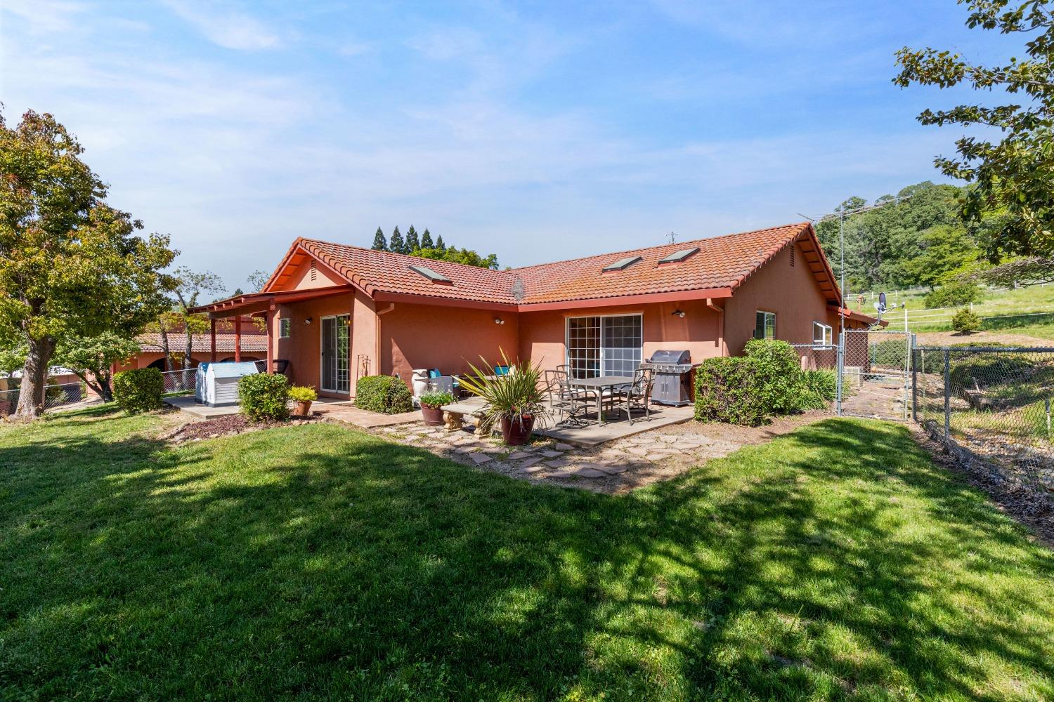 13587 Garden Bar Road Grass Valley, CA 95949 - Photo 22 of 70 a front view of a house with yard porch and sitting area