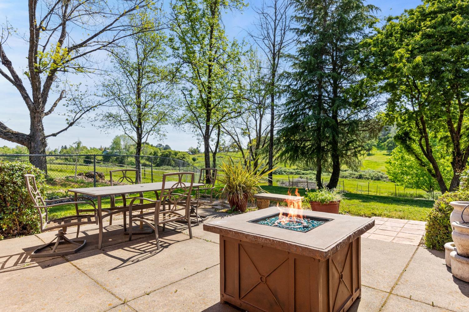 13587 Garden Bar Road Grass Valley, CA 95949 - Photo 23 of 70 a view of a patio with a table and chairs under an umbrella