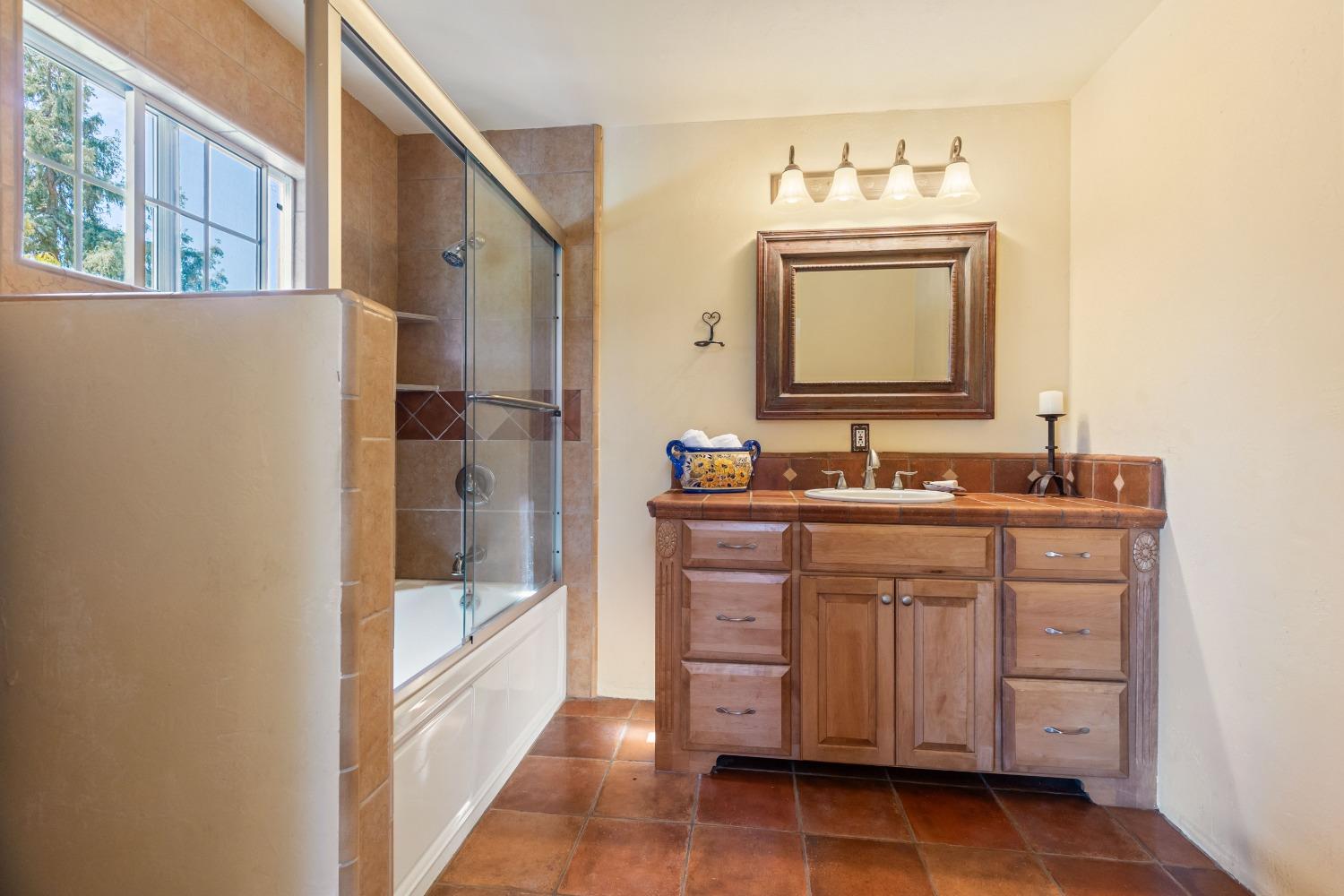 13587 Garden Bar Road Grass Valley, CA 95949 - Photo 26 of 70 a bathroom with a sink a mirror and a bathtub