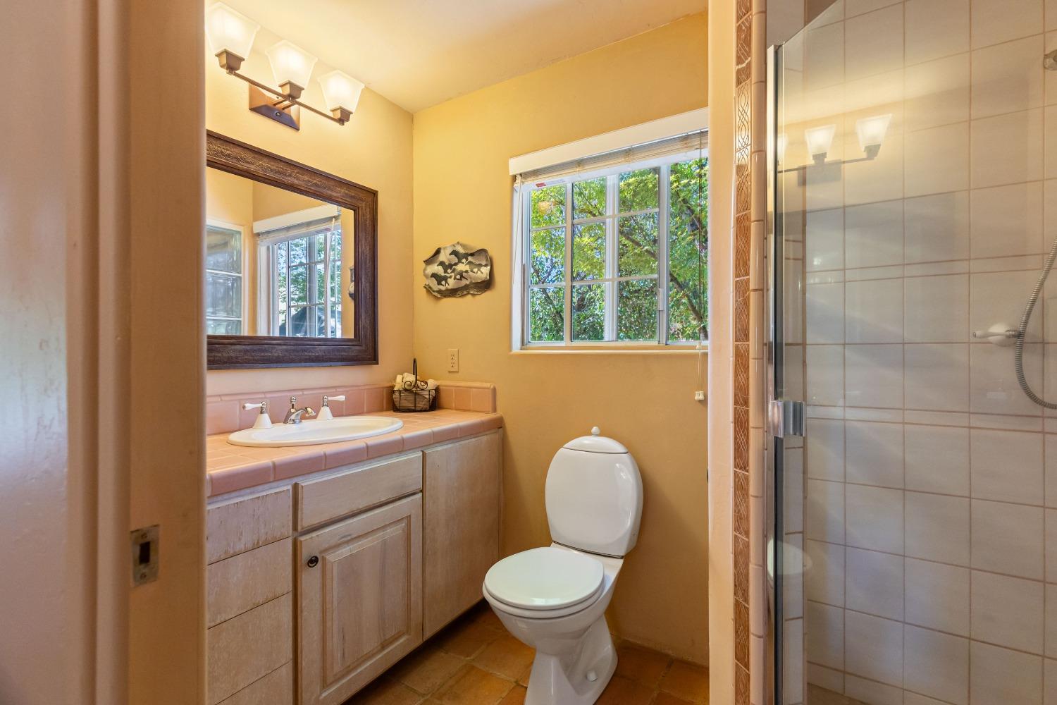 13587 Garden Bar Road Grass Valley, CA 95949 - Photo 28 of 70 a bathroom with a toilet sink and mirror