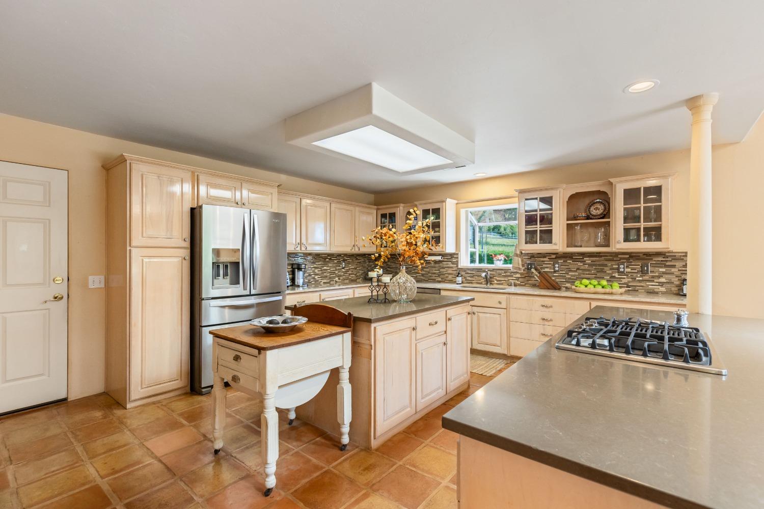 13587 Garden Bar Road Grass Valley, CA 95949 - Photo 8 of 70 a kitchen with stainless steel appliances granite countertop a stove a sink dishwasher and a refrigerator with wooden floor