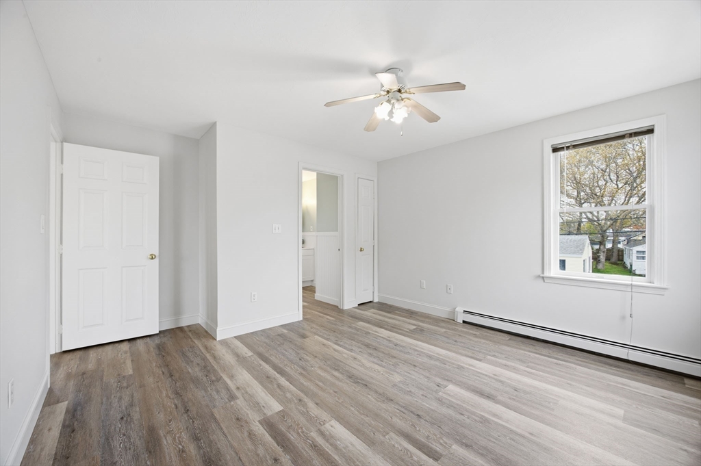 192 Swifts Beach Road Wareham, MA 02571 - Photo 32 of 38 a view of an empty room with wooden floor and a window