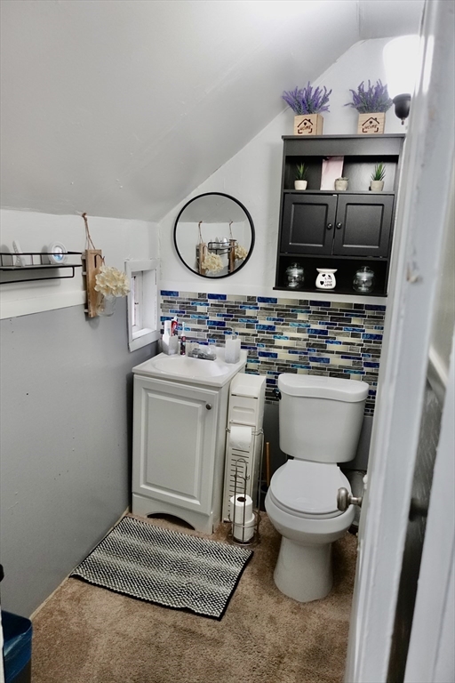 5 Vernon Street Holyoke, MA 01040 - Photo 8 of 12 a bathroom with a toilet a sink and a mirror