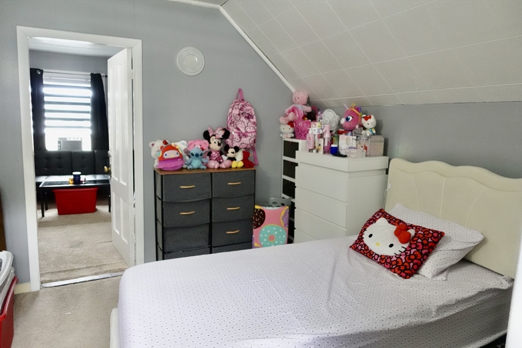 5 Vernon Street Holyoke, MA 01040 - Photo 10 of 12 a bed room with a bed and a dresser