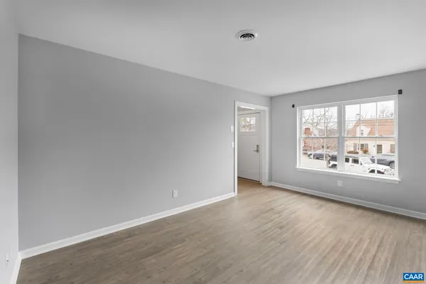 wooden floor in an empty room with a window