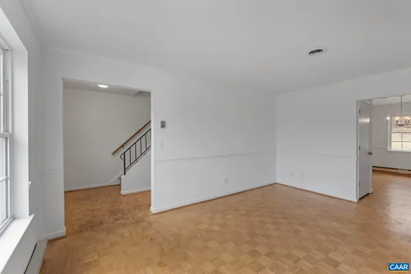a view of a chandelier in big room and hallway