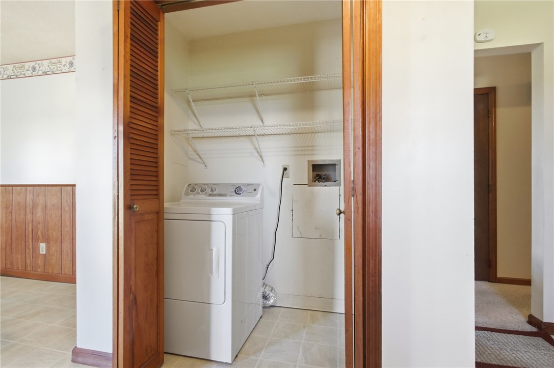 6718 Old Columbus Road South Vienna, OH 45369 - Photo 15 of 33 This dedicated laundry area offers practical convenience with essential appliances and shelving.