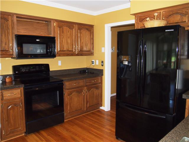 2848 Bolton Road Columbia, TN 38401 - Photo 8 of 20 a kitchen with granite countertop stainless steel appliances and wooden cabinets
