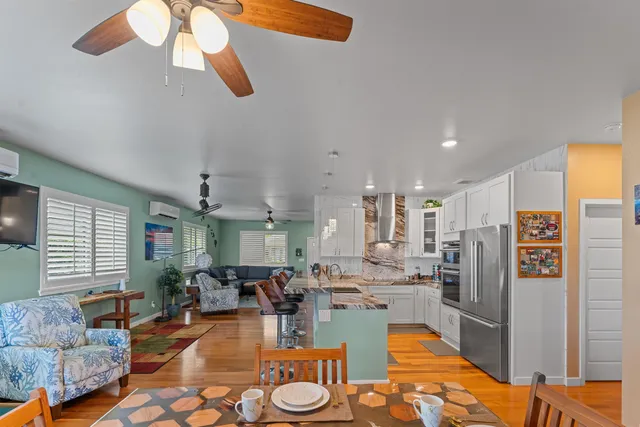 a living room with lots of furniture and kitchen view
