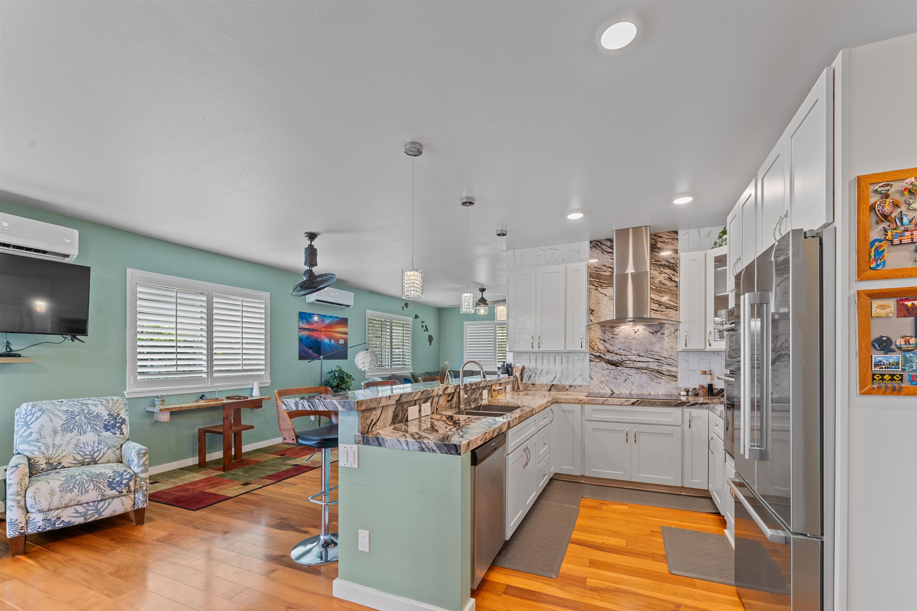 112 Kili'o'opu Street Wailuku, HI 96793 - Photo 15 of 49 a kitchen with stainless steel appliances kitchen island granite countertop a refrigerator and a stove