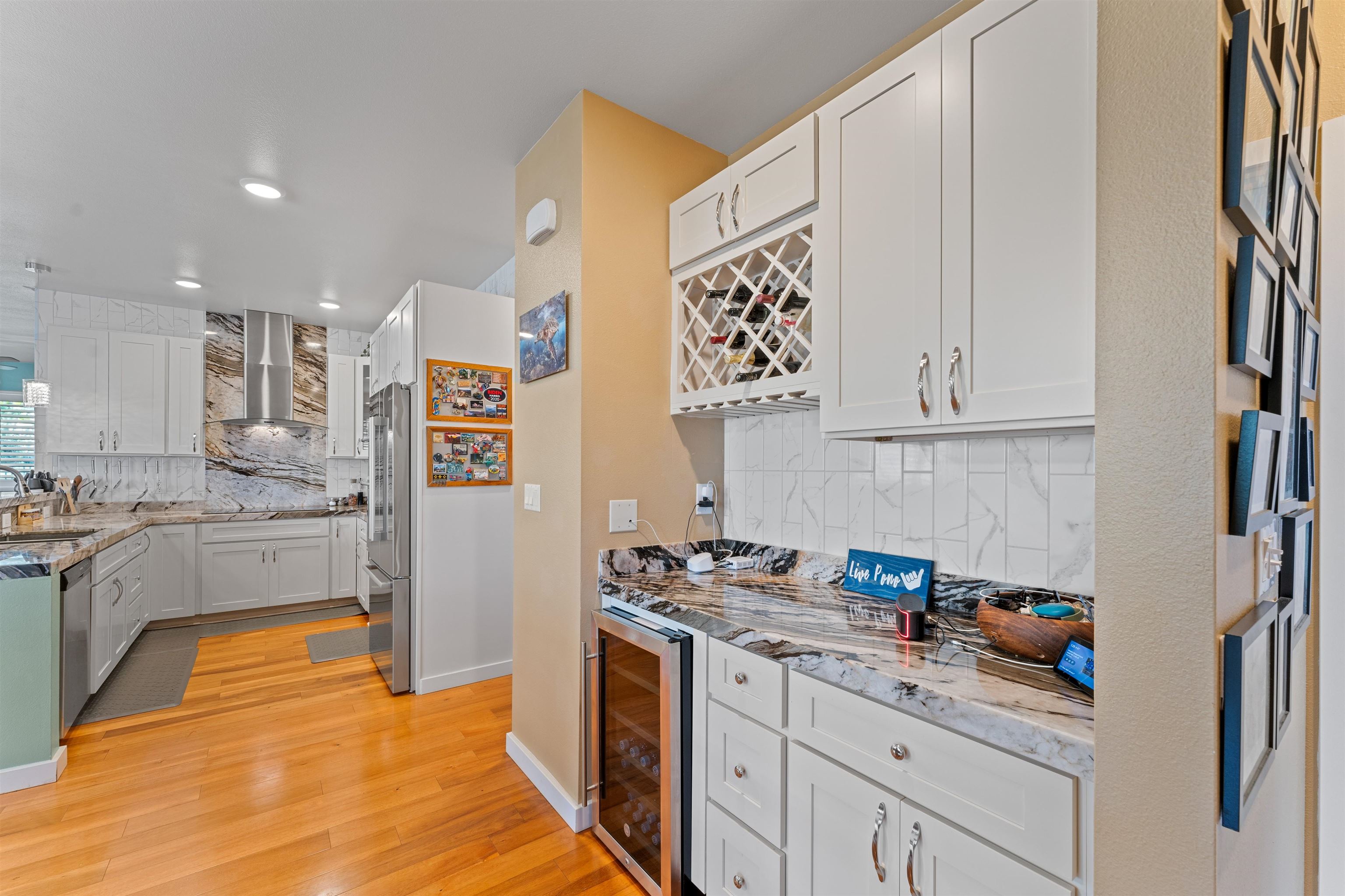 112 Kili'o'opu Street Wailuku, HI 96793 - Photo 16 of 49 a kitchen with stainless steel appliances granite countertop a refrigerator and a stove top oven