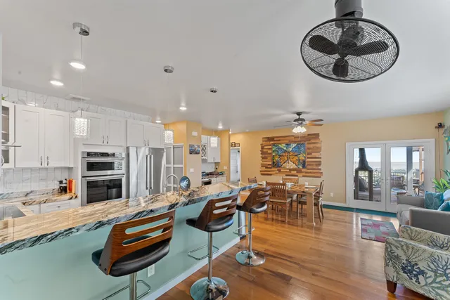 a living room with furniture gym equipment and a view of kitchen