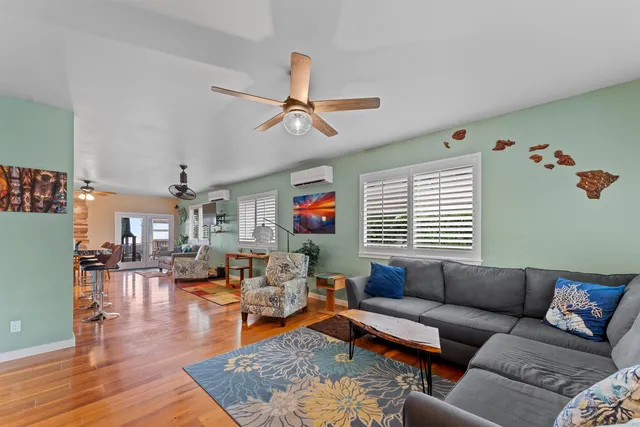a living room with furniture and wooden floor