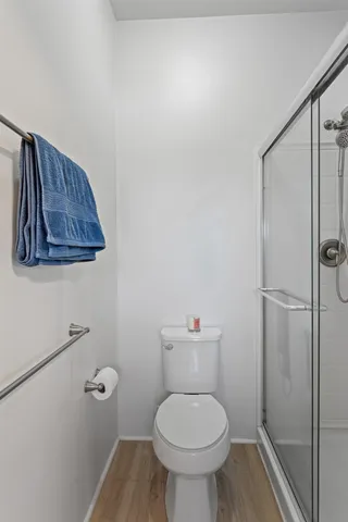 a bathroom with a toilet and a shower