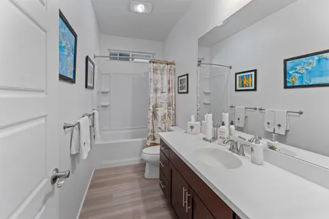 a bathroom with a double vanity sink a toilet and a mirror